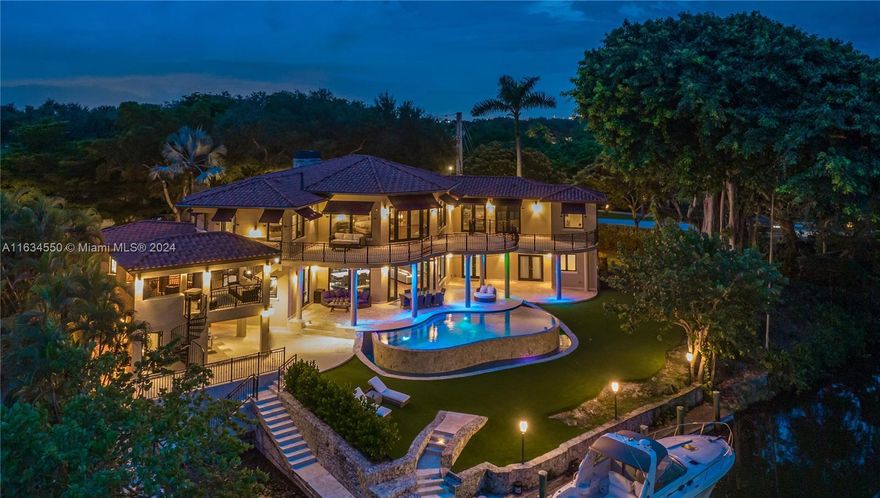 An idyllic waterfront estate, situated on a peaceful double corner lot in the heart of South Coral Gables, set against a picturesque bridge vista, stunning Banyan and mature Oak trees. A true boater's paradise with 197' on the Mahi Waterway, 60' Dock, rare grandfathered 40' boat slip and two high bridges to ocean access. The entire upper level is dedicated to two impressive Master Suites and a spacious loft. Only the finest finishes, with natural stone, mosaic tile and Brazilian Walnut. Breathtaking large living areas, Chef’s kitchen featuring Wolf, Sub-Zero, True, Miele, Hoshizaki and Eagle Group Commercial sink. Master bath features large spa bathtub and sauna. Dual gas fireplaces, Fire Magic summer kitchen, bar and lounge. Crestron Lighting Control System, Commercial Grade Audio system.