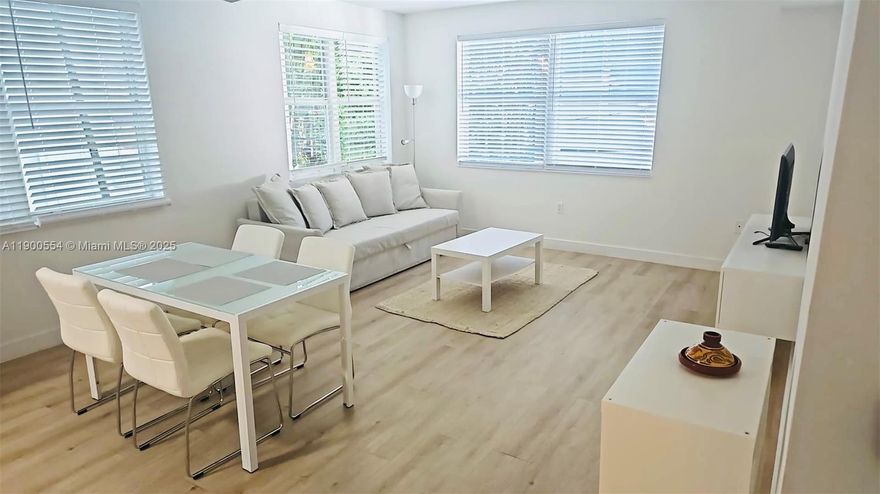 COMPLETELY RENOVATED, STUNNING SUPER BRIGHT 2nd FLOOR UNIT. This sunny and quiet corner 1 bedroom / 1 bathroom boasts an abundance of natural light! Beautiful new laminated floors throughout the entire apartment. Ultra modern and very spacious open kitchen / dining room features stainless steel appliances, quartz countertop, 2 sinks and a window overlooking a bright palm tree view. The tv / lounge area has a large couch and 3 windows. The large bedroom also has a huge window overlooking palm trees. The bathroom was designed with a frameless transparent shower door. The closet is very spacious and there is an in-unit washer & dryer. LOCATION! Ideally located between Lincoln Road & Espanola Way, near restaurants, shopping, cafes and only two blocks from the ocean! NO PETS & NO SMOKERS