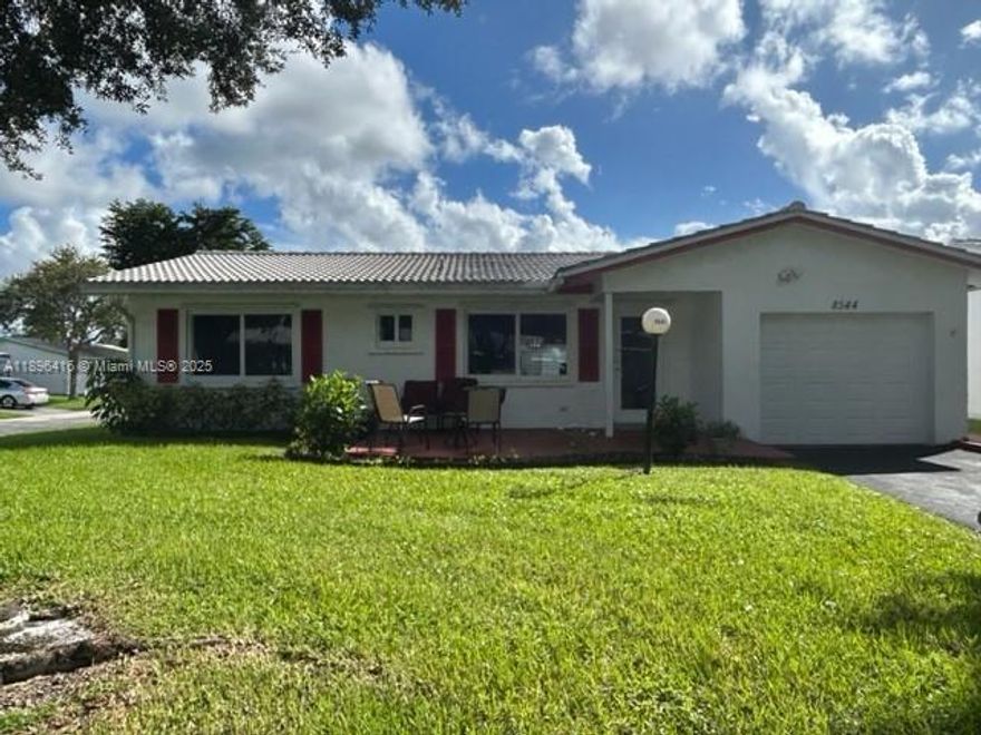 Centrally located Lauderdale West **Corner Lot** 2 bed/2 bath w/garage, 55+ Community with Impact windows and doors. Newer tiled roof 2019, New AC 2024 & New hot water tank 2023. Roof 9 years old. Eat in kitchen, Living room, dining area and separate family room. Large rooms, primary bed w/large walk in closet-ensuite bath with dual sinks, shower & linen closet Washer, Dryer & fridge in garage stays. Assoc. Fee Includes: Fiber Optic HDTV & Internet, Free community bus at your door, Lawn Service, Exterior painting, Huge Clubhouse, 2 Pools Tennis Courts, Pool Tables, Ping Pong, Card rooms, Professional Shows, Fitness Center & more! This home is a must see! Home can be purchased turn key or emptied out if needed.