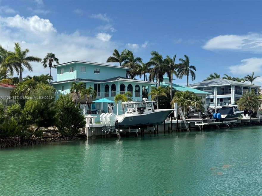 28-day minimum rental. Welcome to paradise! This luxury 4,700+ SF custom home is just 1,100 ft from the ocean inlet with no fixed bridges, 100' wide canal, and ocean views from the 3rd-story loft. Includes two 25K lb boat lifts (up to 40' boats), double jet ski lift, paddle boards, fishing rods, golf carts, and more. Kid-friendly with 6 bunk beds—sleeps 16+. Features hurricane impact windows, custom wood floors, new appliances & HVAC, 24' ceilings, screened lanai, heated/chilled pool & spa, tiki hut with full outdoor kitchen. Fully furnished and first time on seasonal rental market. EV charger onsite. Extra lot for parking. Walk or golf cart to top restaurants. Available: Sept–Nov 2025, Feb & May 2026. Rates vary by month.