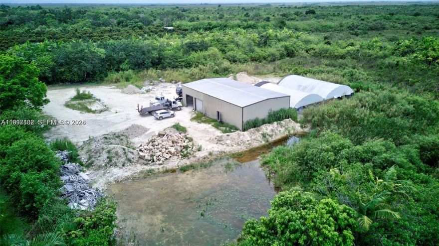 Exceptional 5-acre property in Homestead offering outstanding functionality and future potential. The property features a newly constructed 2024 warehouse (70x40, 2,800 sq ft), two agricultural tents (one set on a new concrete pad), well, septic system, and FPL service with 220V & 440V three-phase power. One acre has been filled and approved for storage, while the remaining four acres are cleared and ready for agricultural use. Fully fenced for security and privacy. Quiet location ideal for farming, business operations, or building a custom residence.