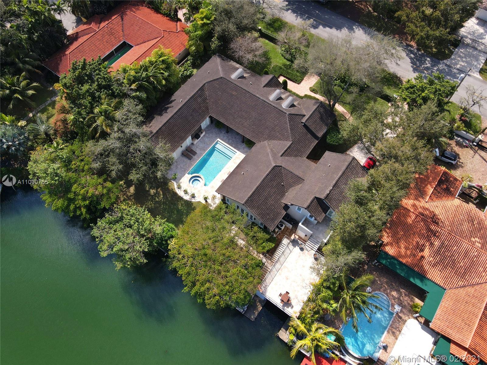 Boating or golf? Take your pick at this stunning, 2007-built & recently renovated home that is on the waterway & across the street from the Riviera golf course. The 6 BR, 5.5 BA property, on walled & gated 24,258 SF lot w/ 150’ on the water, features soaring wood-beamed ceilings, gorgeous finishes, & perfect entertaining spaces. Inside find the stunning formal liv & din rms, casual family rm open to dreamy kitchen, + BR w/ full bath that serves as a den overlooking the water! Outside there is a deep patio, built-in grill, sparkling pool w/ spa, & boathouse w/ huge deck on top! Spacious primary ste w/ beautiful BA & lge closet, separate guest ste, + 3 more ample BRS. Spectacular details abound: generator, mahogany front dr, impact glass, high-end appliances, & more in the best location!