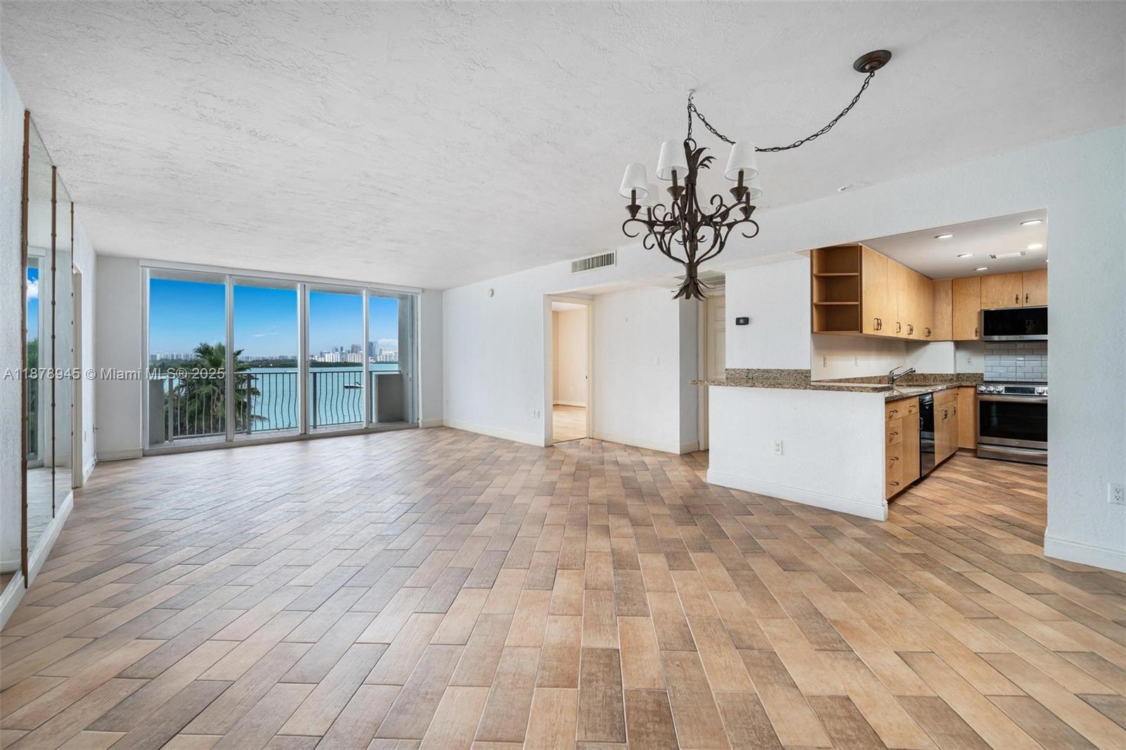 Welcome to this expertly maintained 2-bedroom corner residence in the heart of Bay Harbor Islands, showcasing panoramic views of the Bay, Sunny Isles, and the Ocean. This coveted R-line unit boasts an efficient split floor plan, with a kitchen featuring updated appliances, granite countertops, and wood cabinetry that opens directly to the main living area. The oversized primary suite offers sweeping water views and an en-suite bathroom. Island Pointe is the only gated building on Bay Harbor Islands, with amenities including a pool, BBQ area, boat slips, and more. Ideally located within walking distance to Bal Harbour Shops and just a short drive to Miami Beach, the airport, and beyond. Two parking spots included—live the Island lifestyle today!