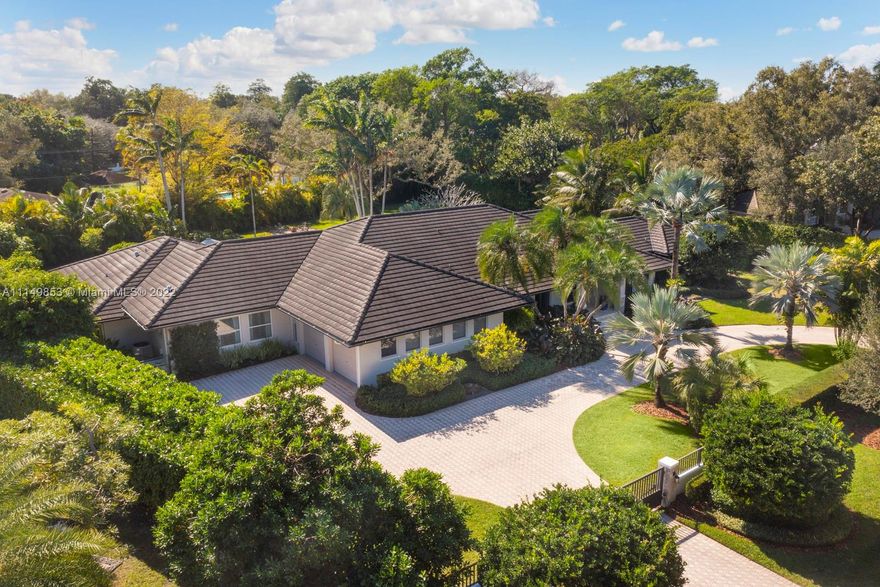 Gorgeous sophisticated fully gated and private acre family home on one of the most desirable streets in all of Pinecrest!  Superb split plan layout which includes master + office on one side, and 4/3 on other side including large kids family room/playroom.  2020 whole house gas generator, 8-year old flat tile roof, new resort style pool area, huge bedrooms, large kitchen w/gas range, and enormous and oversized covered patio with built-in grill.  Expansive yard space with field to play, fire pit and a beautiful lush landscape perimeter. When only the best of North Pinecrest will do!