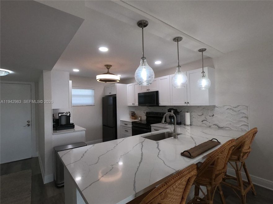 Exquisitely renovated 2BR/2BA residence offering refined, resort-style living within a sought after 55+ community. This light-filled condominium enjoys tranquil pool views from a private screened terrace with accordion shutters, creating an ideal setting for relaxed Florida living year-round. 

The thoughtfully designed interior features impact windows, water-resistant laminate flooring, and the convenience of an in-unit washer and dryer. The open concept kitchen is both elegant and functional, showcasing rich wood cabinetry, quartz countertops, a designer tile backsplash, and sleek black stainless steel appliances, seamlessly connecting to a spacious dining area ideal for entertaining.

The expansive primary suite offers dual walk-in closets and a dedicated sitting area, providing a private retreat. Both bathrooms have been completely reimagined with sophisticated, contemporary finishes. Maintenance includes cable, HBO, and internet, enhancing the ease of ownership. 

Impeccably updated and truly move-in ready. This is effortless Florida luxury living at its finest. Unit is offered unfurnished; furnishings may be negotiated separately with the seller.