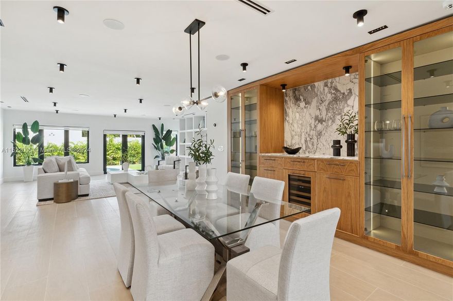 Custom home in The Roads!. Fully-remodeled and finished in 2024, the property features 4bd/5ba (3,452 sqf. under A/C) within a 10,000sqf lot. High-end finishes include wide-plank floors, oak cabinetry, 7 custom-built closets, designer lighting, smart switches and in-ceiling speakers. Kitchen designed by D’CASSA with Arabescato marble countertops, oak cabinetry and Wolf/Sub-Zero appliances. Luxury bathrooms with marble/limestone floors and walls and over-sized showers. Primary suite includes 3 walk-in closets, motorized shades and travertine bath. Featuring lush landscaping, summer kitchen, pergola, outdoor shower/toilet and pool-side audio system. Fully protected, equipped with brand new metal roof, impact windows/doors, motorized fence and smart security system.