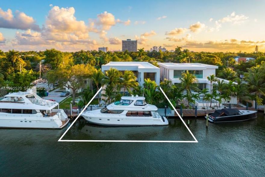 Experience elevated luxury in this newly built gated waterfront estate, nestled within the prestigious 24/7 guard-patrolled community of Belle Meade. Quietly positioned on a generous 10,710 SF lot, this smart home offers 6 bedrooms and 6.5 bathrooms across 6,902 SF of refined interior living space, thoughtfully designed for comfort and tranquility. A striking pivot door welcomes you into a dramatic 21-foot foyer, revealing expansive interiors with 11-foot ceilings and sleek modern finishes throughout. The main living areas flow seamlessly, anchored by a custom kitchen outfitted with Wolf and Sub-Zero appliances, elegant cabinetry, and a spacious walk-in pantry—perfect for both everyday living and entertaining. Designed for year-round enjoyment, the outdoor spaces feature a heated  pool, fully equipped summer kitchen, and covered lounge areas surrounded by lush tropical landscaping. With 70 feet of private dockage and direct access to Biscayne Bay with no fixed bridges, this property is ideal for boating enthusiasts. Blending privacy with contemporary design, this exceptional waterfront residence offers effortless sophistication just minutes from Miami’s Design District, beaches, and downtown—truly a modern coastal masterpiece.