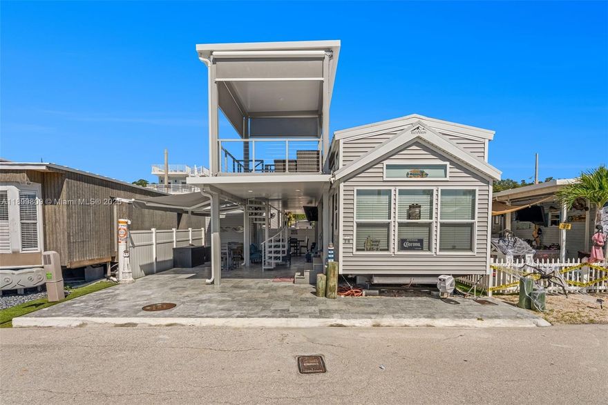 SEE  VIRTUAL TOUR   LINK ABOVE FOR FULL UNBRANDED VIDEO TO SHARE WITH CLIENTS - Open Ocean - Calusa Campground Lot 318 with anchored residence, dock, storage and golf cart - furnished and turnkey - Beautifully renovated residence sleeps 10 -plus- a rare 2nd story entertainment deck offering miles of open ocean views. Marble stone paved lot, opulent outdoor kitchen and entertainment space plus additional storage. Dock with lift and power, literally seconds to open ocean. Beautiful residence interior with 4 sleeping areas, renovated full bath, fully updated kitchen plus multiple AC zones for comfort and efficiency. Boat available. The Best of Calusa - open ocean access lot, fully updated interior and exterior with second story observation deck and dock with lift.  Seller financing available.