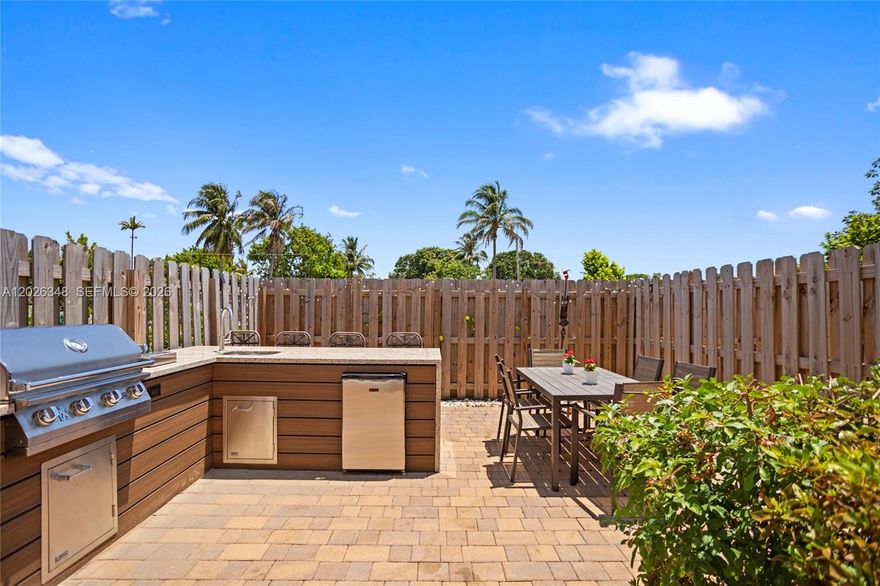 Move-in-ready luxury in Westview — Miami's newest gated community, just 1.8 miles west of I-95. This impeccably maintained 2-year-old, 3-bedroom, 3-bath home delivers the rare advantage of new construction without the builder wait, enhanced by more than $30,000 in thoughtful owner upgrades.
The intelligent floor plan features a sought-after first-floor bedroom with full bath — ideal as a guest suite, private home office, or in-law accommodation. Designer tile flooring, upgraded lighting, and custom blinds set a refined tone across the main level. Upstairs, two spacious bedrooms each include en-suite full baths, anchored by a serene Owner's Suite with double vanity and oversized walk-in shower. Custom closets throughout maximize storage and organization in every room.
The true showstopper is the private backyard retreat: a fully equipped outdoor kitchen with built-in grill, fryer, sink, and refrigerator turns weekends into year-round Florida entertaining. LVP wood-grain stairway accents, modern finishes, and a fresh, neutral palette complete the elevated feel.