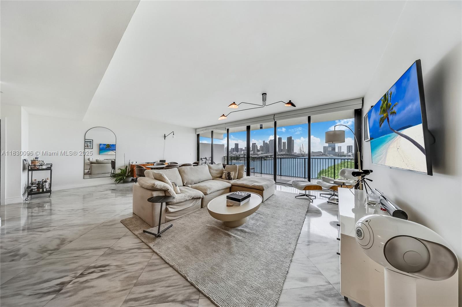 Experience elevated bayfront living at 1000 Venetian Way. This beautifully renovated 2 bedroom, 2 bath residence offers panoramic views of Biscayne Bay and the Miami skyline from an expansive terrace framed by floor-to-ceiling impact glass. Marble floors flow throughout the open-concept layout, while a sleek Italian kitchen anchors the home with a large center island, custom cabinetry, premium Miele appliances, and refined finishes. The oversized primary suite features a modern bathroom and generous walk-in closet. Located on the iconic Venetian Causeway, this exclusive waterfront building offers resort-style amenities including two pools, fitness center, tennis courts, and 24-hour concierge.