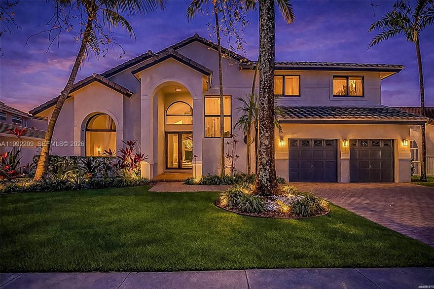 Fully reimagined modern residence in the gated Silver Lakes community, blending high-end finishes with a true indoor-outdoor lifestyle. Renovated throughout, this two-story home features volume ceilings, wide-plank flooring, recessed lighting, & a striking glass-railing staircase. Skylights & oversized windows fill the home with natural light, enhancing the open-concept layout. The kitchen is anchored by an oversized island with seating, dark stone countertops, shaker cabinetry, a Frigidaire double-wall oven, electric cooktop with vent hood, & built-in wine refrigerator. The primary suite features a freestanding soaking tub, frameless glass shower, dual vanity with matte black fixtures, and large-format tile. Upstairs also includes two guest bedrooms, a loft den, & a guest bath with double floating vanity & tub/shower combo. A first-floor bedroom with en-suite bath provides flexibility for guests. The backyard is designed for entertaining, featuring a pool with integrated spa and water spillover, sun shelf, natural stone pavers in a French pattern, & a covered lounge pavilion with TV. The summer kitchen is equipped with a Coyote grill, flat-top griddle, ice maker, built-in refrigerator, sink, & stone countertops. The fenced yard is framed by mature hedges & tropical landscaping. A two-car garage, impact windows & doors throughout, & major system updates in 2021, including roof, two-zone A/C, & water heater, complete package. HOA includes cable, WiFi, & community amenities.