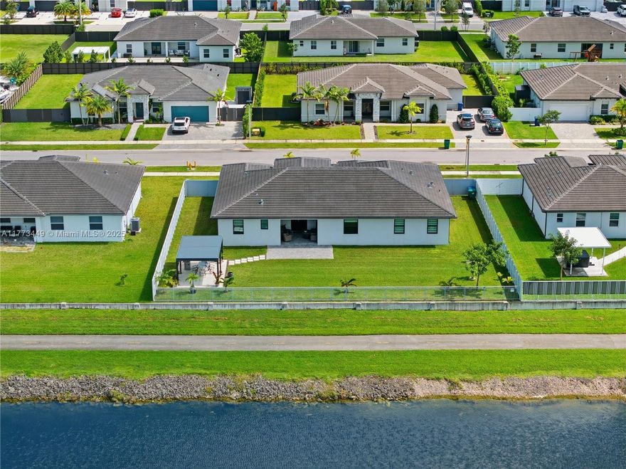 Why wait months & pay builder premiums? Own this better-than-new 2022 waterfront smart home with over $130K+ in upgrades! All windows upgraded to hurricane-impact glass with Espresso finish frames (rated 170+ mph), privacy fencing w/gates, security system, upgraded outdoor recessed lighting that can change colors, gutters, water treatment system, $20K in flooring, custom closets, window treatments, pergola w/louvers, landscaping, and paved terrace/driveway. NO HOA on a quiet cul-de-sac with direct access to an 80-ft navigable canal to Black Point Marina & a two-way bike path you can ride to Larry & Penny Thomson Park. West-facing backyard offers stunning sunsets. Huge 12,000+ lot with space for a pool, RV, boat, & jet skis. Excellent family-oriented neighborhood with lots of children.