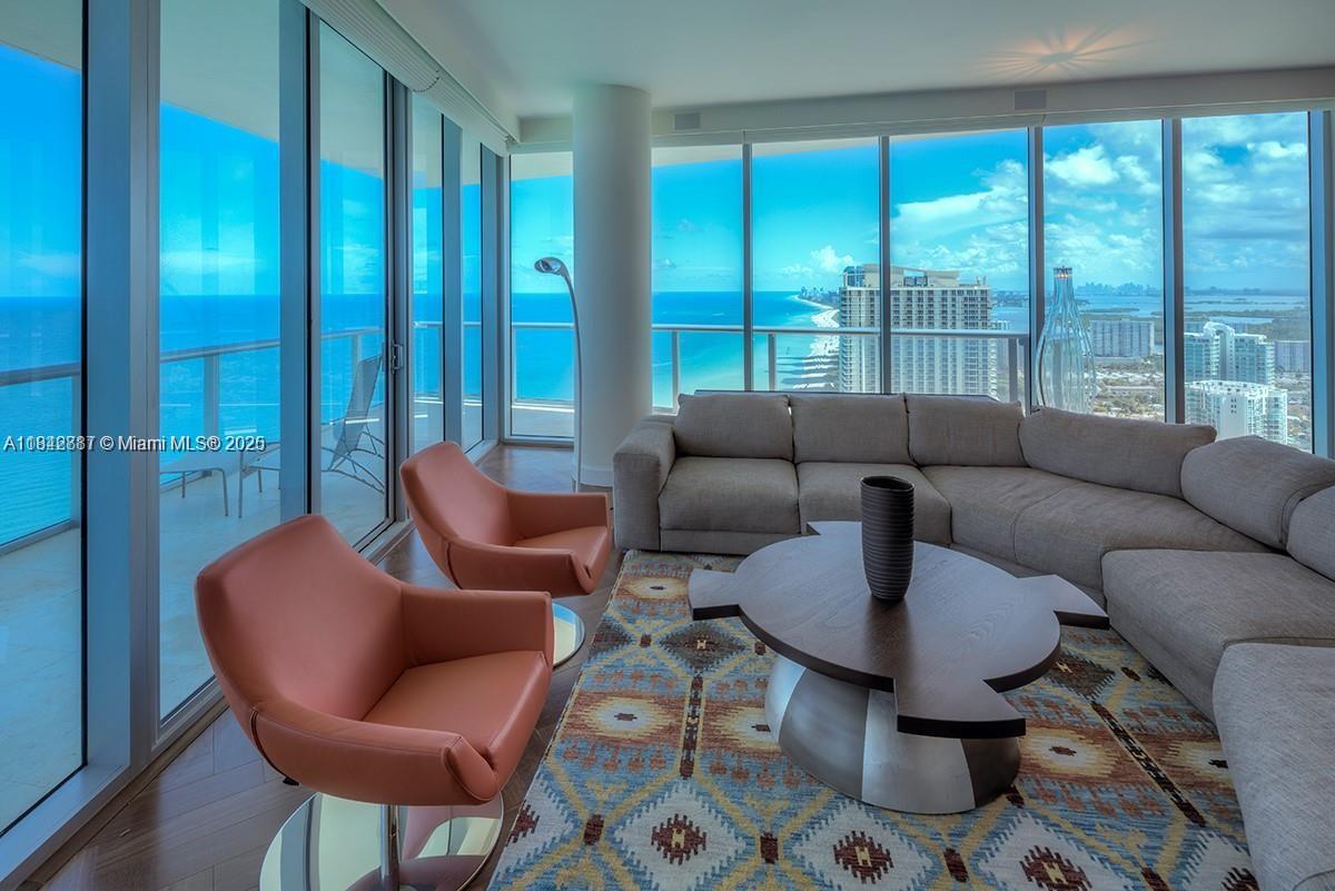 Stunning designer-furnished penthouse on the coveted SE corner of the 43rd floor at Jade Beach! This 4 bed / 5.5 bath residence features 12' ceilings, floor-to-ceiling windows, electric blinds, and two main bathrooms in the primary suite. Private elevator entry, panoramic ocean views, and a BEACH FRONT CABANA included. Enjoy luxury spa amenities, beach service, and iconic beachfront living.