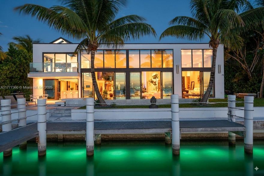 Welcome to an extraordinary waterfront retreat in the heart of the gated community of Biscayne Point Island, where stunning breathtaking wide water views capture unforgettable sunsets. Originally designed by renowned architect Barry Sugarman, this designer residence seamlessly blends modern waterfront living with a boater’s paradise. Featuring 98 feet of water frontage, this 5 bedroom, 6.5 bath residence is a sanctuary for boating enthusiasts, boasting a stunning primary suite, rare 16-foot-high ceilings, multiple entertaining spaces, and an expansive living room designed to impress. Thoughtfully crafted with sophistication and comfort in mind, the home exudes elegance and timeless charm.