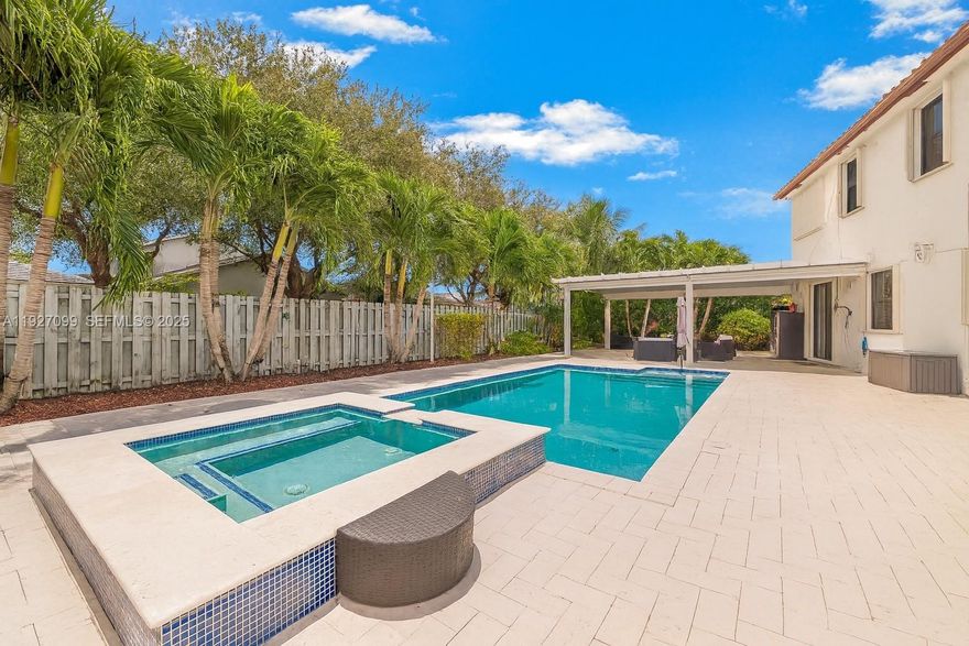 Discover the perfect blend of space, elegance, and resort-style living in this stunning two-story home set on an impressive 11,980 sq. ft. lot. Boasting a 3-car garage and an expansive driveway, this residence offers both comfort and convenience for families, entertainers, and those seeking elevated living. With 5 bedrooms, 4 bathrooms, and 4,320 sq. ft. of living area, there is truly room for everyone.Step inside to find a beautifully updated kitchen and two remodeled bathrooms, all completed in 2022 with modern finishes and thoughtful design. Wood stairs and contemporary light fixtures add a sophisticated touch, enhancing the home’s warm yet refined ambiance. The outdoor space is a true Florida oasis. Enjoy travertine flooring throughout the backyard, an aluminum terrace, and a charming wood gazebo perfect for gatherings. Relax in your private pool and Jacuzzi, equipped with colored lighting and a propane gas heater—ideal for evening dips or weekend fun. Additional upgrades include two water filtration systems, a sprinkler system, and accordion shutters throughout, ensuring comfort and peace of mind year-round.
Located inside a secure gated community, residents enjoy top-tier amenities including a gym, playground, community pool, and splash water park—everything you need for a vibrant and active lifestyle. This exceptional property offers the perfect combination of luxury, functionality, and outdoor enjoyment—ready for its next owner to call home.