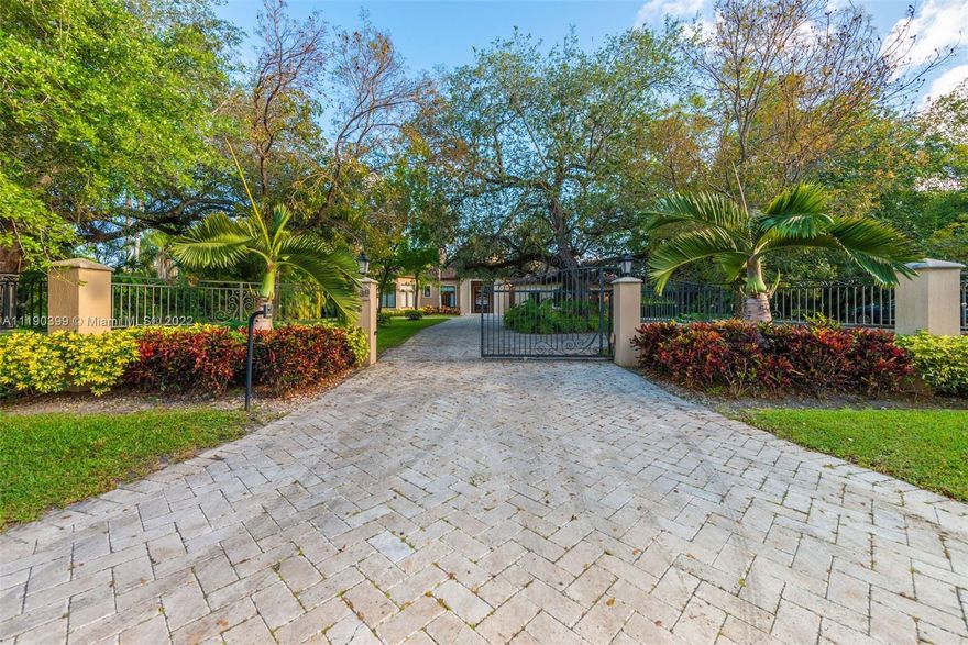 North Pinecrest One Story, Contemporary Villa on over One Acre surrounded by lush landscaping and nested with mature live oaks. Imposing entry and living room with 25' soaring ceilings. Luxurious use of high end finishes and materials. LaFinestra impact windows and doors, plenty of natural light, motorized blackout blinds and curtains in all rooms. Gourmet chef's dream kitchen with Wolf/Miele appliances, two professional ovens (electrical and gas). Bedrooms offer Bathrooms in-suite with granite slab baths, large closets, spectacular outdoor luxury yard with resort style heated pool and spa, tanning ledge. Detached Summer kitchen offers built in BBQ and bar areas perfect for entertaining. Smart system control pools light and temp. Wall and gated!