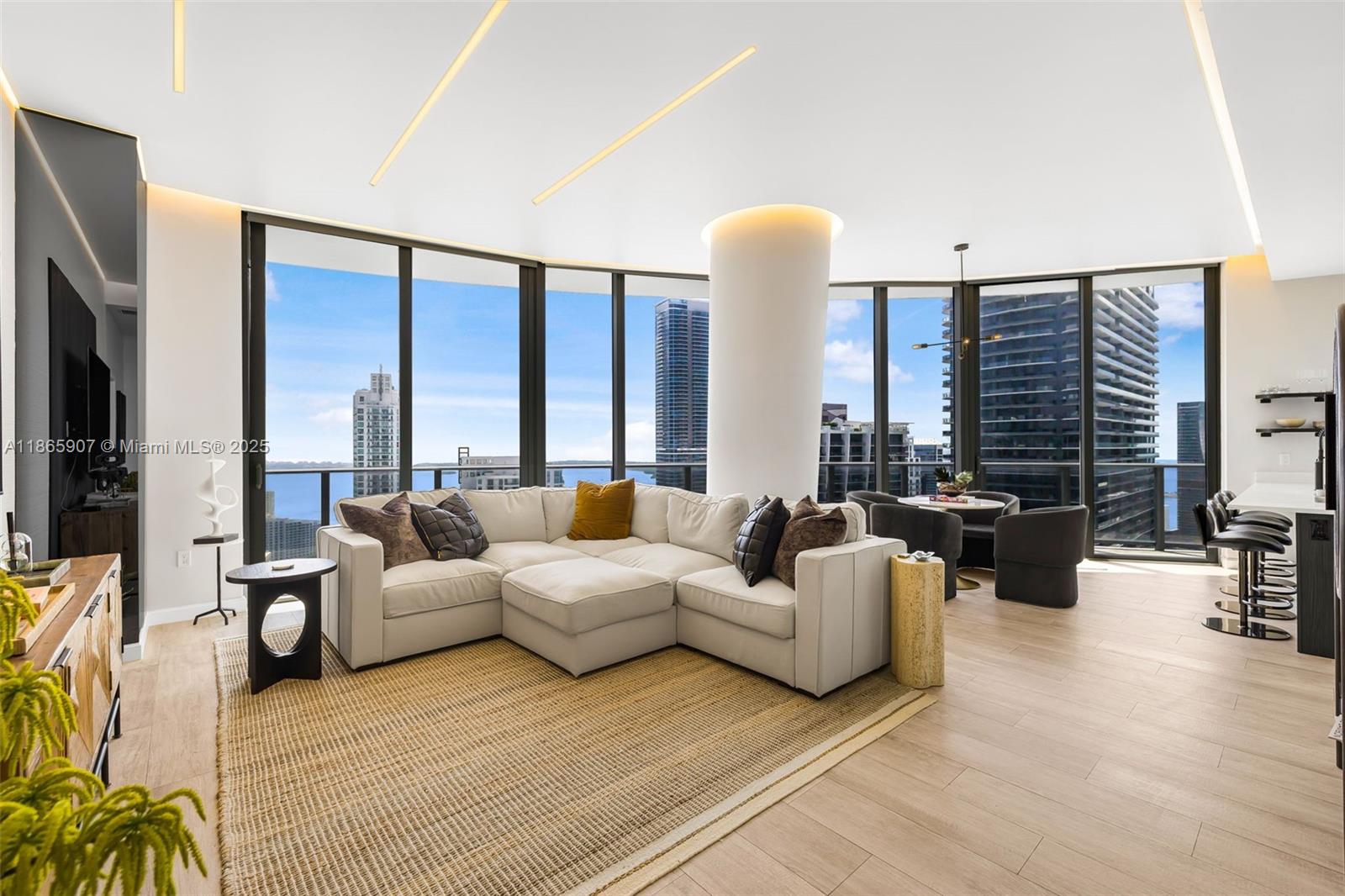 A must-see, move in ready, interior design gem. This Lower Penthouse in the sought-after 03 line of Brickell Heights, features soaring 11-foot ceilings and world-class finishes. This 2-BR + den, 3-BA residence showcases custom European woodwork throughout, including a hand-carved TV wall unit, designer kitchen cabinetry, and solid wood doors that set a new standard for elegance. Step onto the expansive wrap-around balcony with breathtaking views spanning from Downtown Miami to Coconut Grove. Luxurious design details include Italian Goldflake wallpaper, a custom foyer partition, Somfy automatic shades and LED lighting with individual remote dimmers. Residents of Brickell Heights enjoy spectacular amenities, including rooftop pools, a fitness center, spa, theater, and private club lounge.