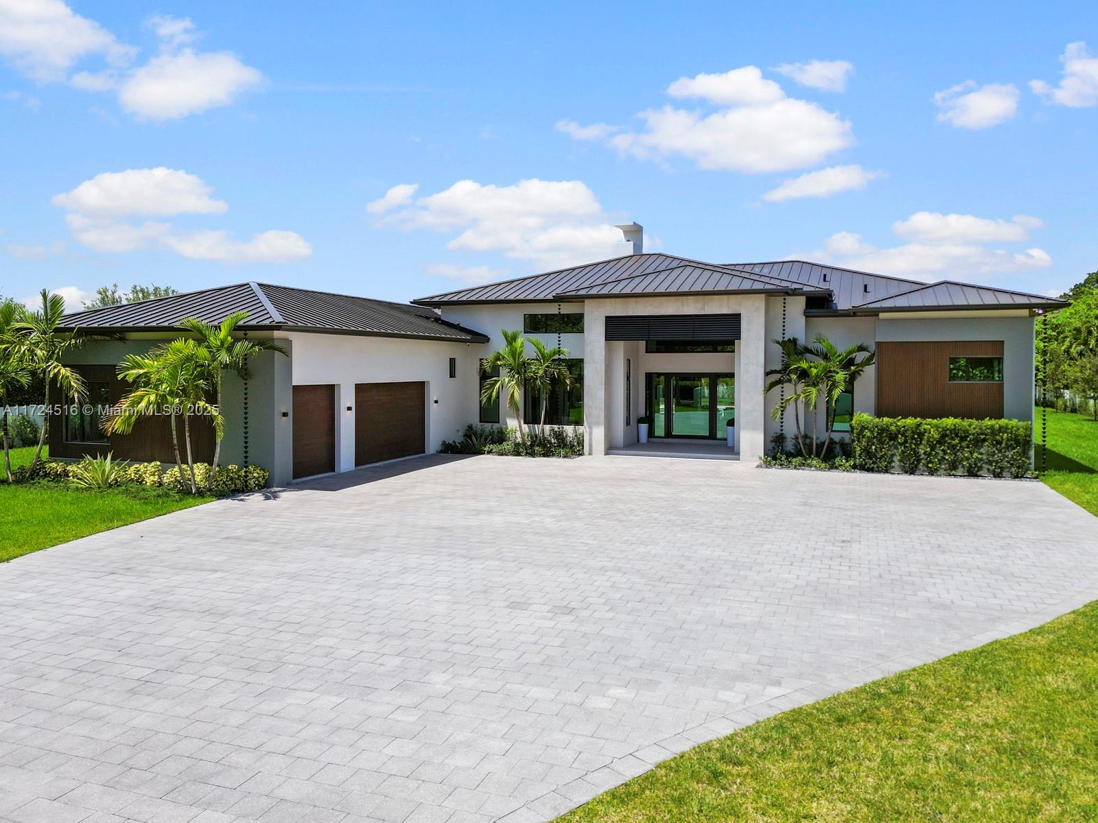Newly custom-built estate in the coveted Horse Country area, completed in 2025 & situated on over an acre of land with 7,471 total sqft. Designed for ultimate comfort, this home features soaring 17ft ceilings, expansive living spaces, a fireplace, gourmet kitchen, maid’s quarters & a versatile playroom/office. The outdoor area is perfect for entertaining, with a vast terrace, summer kitchen & oversized tanning deck/pool/jacuzzi. Smart tech ready w/surround sound, security cameras & alarm system. Built with premium materials like a metal roof & impact windows, the home also includes a buried 1Kgal propane tank. Additional features include a gated entry, oversized paved driveway, and a spacious 3-car garage. This perfect blend of modern sophistication and serene country living awaits you.