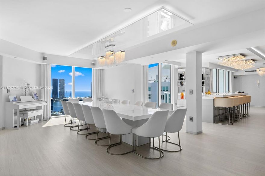 A truly rare offering. This stunning 6-bedroom, 6.5-bath Penthouse has been reimagined with over $1 million in custom renovations, showcasing a seamless fusion of sophistication, comfort, and state-of-the-art design. Spanning more than 5,500 square feet. This residence offers a thoughtfully designed floor plan and breathtaking panoramic views from every room. The gourmet kitchen is a chef’s dream, featuring an oversized island, premium built-in Miele appliances, and sleek, modern finishes. Ideal for entertaining and daily culinary enjoyment. Additional highlights include a stylish bar, custom wine cellar with cigar storage, and extensive built-in closets throughout the home. The oversized primary suite offers unmatched luxury with floor-to-ceiling windows framing spectacular water views.