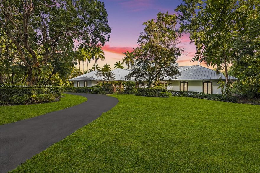 This exclusive North Pinecrest gated residence awaits! Nestled on nearly an acre of lush tropical landscape, featuring an array of fruit bearing trees (papaya, mango, avocado, noni, banana, etc.), screened in patio with an oversized pool, expansive covered terrace, tiki hut, basketball, and tennis court. Come inside and enjoy comfortable living spaces, vaulted tongue and groove ceiling, a fully equipped bar, double sided brick fireplace, and French doors leading to alfresco spaces, perfect for entertaining. Retreat back to your spacious primary bedroom with his/her bathrooms and a sauna. Enjoy privacy and peace of mind with a metal roof, a new septic tank and a whole house generator. This home has been meticulously cared for ensuring its status as a gem in the esteemed Pinecrest community.