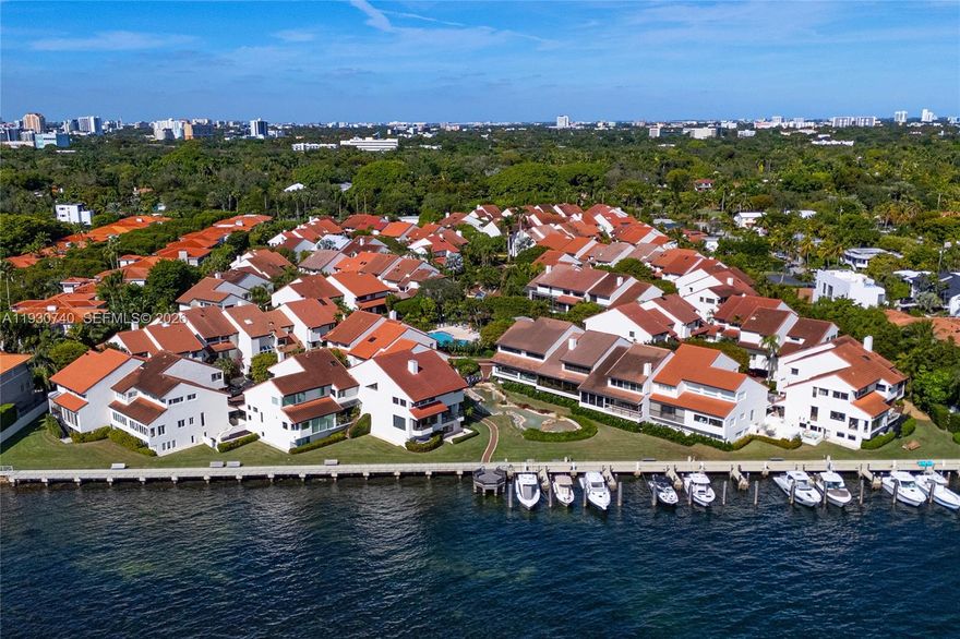 A great opportunity to make a piece of L’Hermitage yours. On the edge of Biscayne Bay and in the heart of Coconut Grove, rests this private and idyllic community. Enjoy the space and feeling of a home with five-star amenities like a heated pool and jacuzzi, lighted tennis courts, 24/7 manned guard gate, walking paths, and sparkling water views. The villa offers six parking spots with two-car garage, carport, plus driveway and an elevator for ease and accessibility. Reimagine or move right in with high ceilings, expansive living spaces, dedicated home office, Mia Cucina kitchen, and custom built-in library with rolling ladder. The primary suite features vaulted ceilings, two walk-in closets, and oversized bathroom. Boat docks are individually owned but come available on occasion.