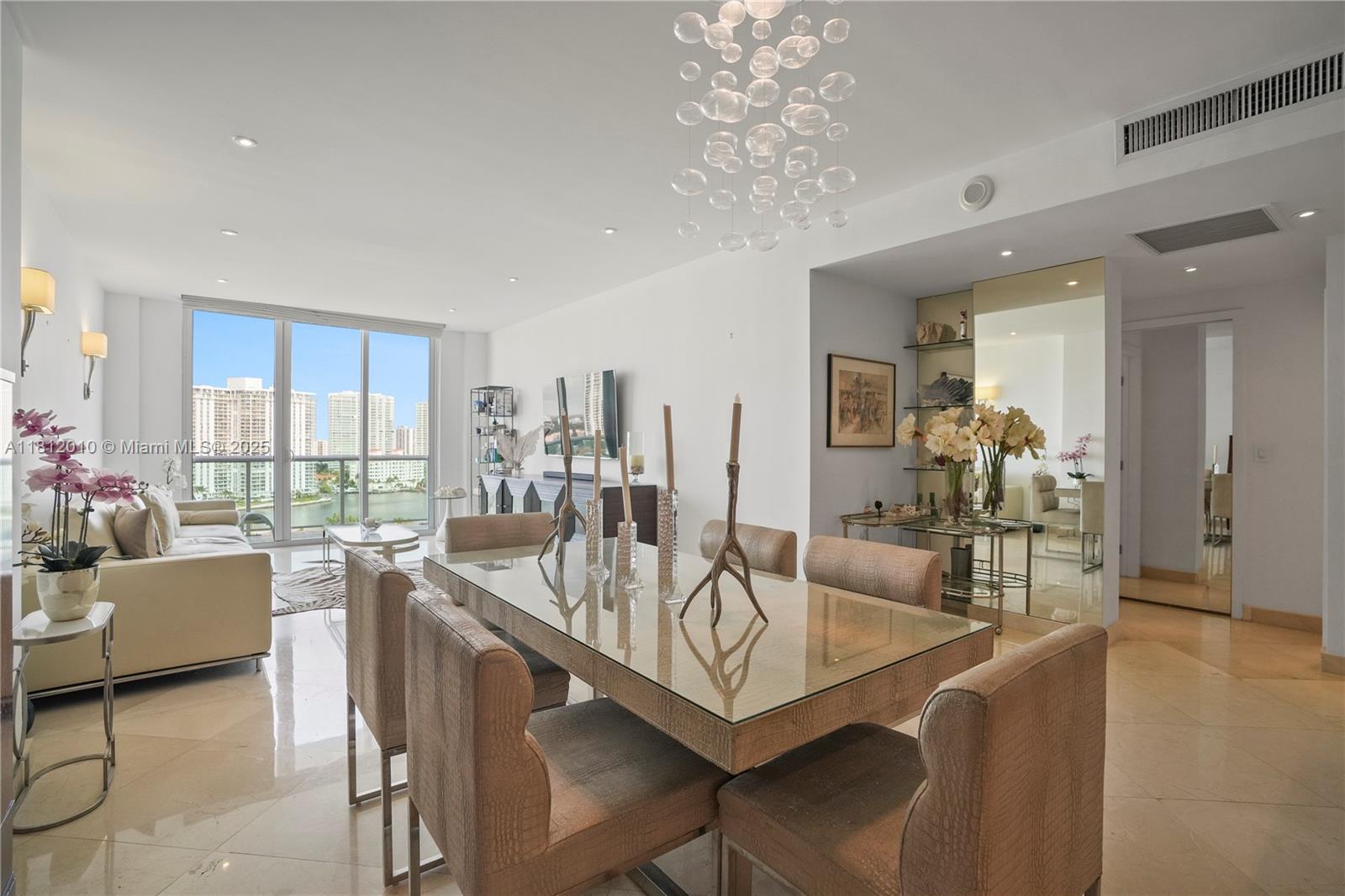 This sophisticated furnished turnkey 1-bed 1-bath condo inclusive of 2 storage units - spans 1,005 sqft situated in Ocean Reserve offering a lifestyle with stunning city, river, water views. Be greeted by high ceilings and floor-to-ceiling windows complete with window treatments, ensuring light-filled spaces. Kitchen space for gatherings, featuring an island, stainless steel appliances. Spacious bedroom with a custom walk-in closet. Enjoy a private balcony, cityscape and water views. Amenities include a pool, spa, barbecue area, common courtyard and a playground. Onsite restaurants provide delicious food and drinks. The building offers a gym, tennis court, billiards room, and more. Sunny isles beach is your backyard with access by foot. Simply walk over for a vacation experience.