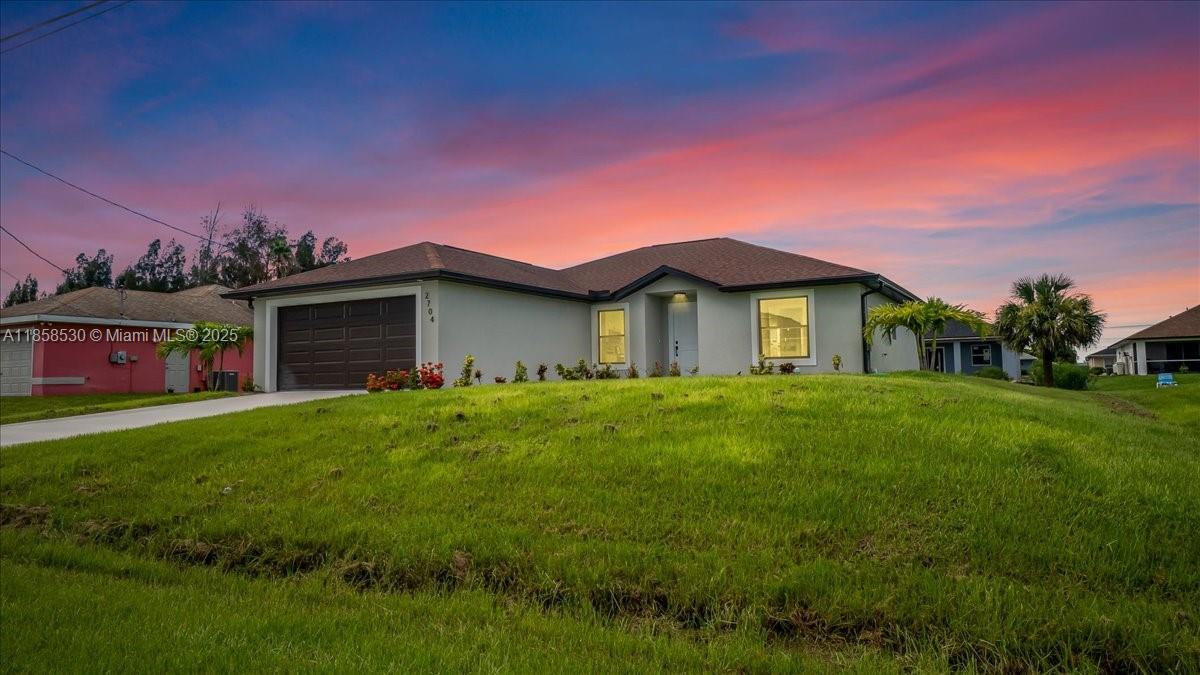 Be the very first owners (never lived in) of this stunning 2024-built 3-bedroom, 2-bath home offering modern design, premium finishes, and peace of mind with impact-resistant windows and doors. Step inside to a bright and open floor plan with vaulted ceilings, recessed lighting throughout, and tile floors in every room for a seamless, low-maintenance look. The sleek two-tone kitchen features stainless steel appliances, a large island with breakfast bar seating, and ample storage, while the split-bedroom layout provides privacy for the spacious primary suite with walk-in closet and en-suite bath. Seller is adding upgraded tiled showers in both bathrooms before closing, and a full-perimeter gutter system is already in place to protect your investment.