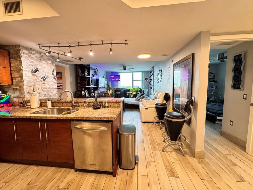 Experience luxury living at Tao Sawgrass in this beautifully upgraded 2-bedroom, 2-bath condo. This residence features elegant wood-look porcelain tile flooring throughout, a stylish open kitchen with granite countertops and stainless steel appliances, spacious bedrooms with walk-in closets, and modern bathrooms. The expansive balcony offers breathtaking panoramic views of the pool, serene lake, and the Everglades, making it the perfect place to enjoy stunning sunsets every evening. The unit also includes 2 assigned parking spaces. Tao Sawgrass is a full-service high-rise offering resort-style amenities, including an state-of-the-art fitness center, sauna, tennis court, clubhouse, business center, and 24/7 security. Ideally located just steps from Sawgrass Mills Mall.