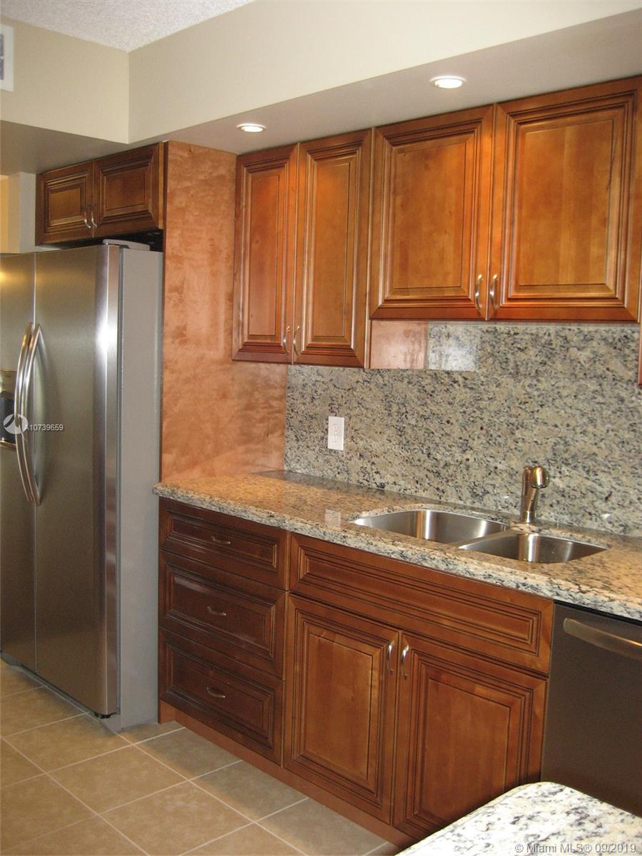 RARELY AVAILABLE AND completely remodeled! Huge sq footage in this 1st floor end unit. Enjoy the easy access with parking directly in front. Gorgeous view from your screened balcony overlooking large lake and fountain! 2BR /2BA condo is TOTALLY BRAND NEW! Kitchen and 2 baths w/ new solid wood cherry cabinets & full granite counter-tops. All brand new Stainless Steel appliances. Brand new washer and dryer. All new lighting and ceiling fans. Plantation shutters are a bonus. New tile and wood floors throughout the unit. Fresh and newly painted with designer colors. BOTH bedrooms have huge walkin closets w/ built ins. Whole unit has accordion hurricane shutters. No expense spared using top of line materials. Fantastic 55+ golf course community w every possible amenity. Hurry , will sell fast!!
