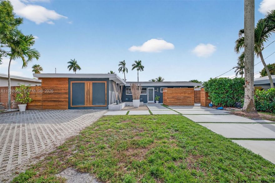 Completely renovated waterfront home in Lauderdale Isles with ocean access and no fixed bridges. This 3BD/2BA home includes an additional 200' sq ft shed completely enclosed with drywall & recessed lighting. Fully reconstructed with permits: Roof (2024), new electrical lines/panels. New plumbing throughout including underground PVC lines, and tankless water heater. Open layout with vaulted ceilings. Beautifully renovated kitchen featuring a large island, white cabinetry, granite counters, and 36 inch double Subzero fridge & freezer—ideal for entertaining. Large flex space in primary bedroom ideal for custom closet build out & gym/office - bath with rain shower & fireplace over stand alone bathtub. Impact windows and doors!! New plank laminate flooring installed throughout main living areas. AC 2023. Elegant front courtyard entry offers privacy and tranquility. Enjoy 60’ of waterfront with dock equipped with 30/50 amp shore power. Stunning outdoor space with artificial turf, pavers, and firepit. Large driveway intentionally designed for RV/boat parking with two EV chargers. No HOA. Prime location near 595, I-95, FLL Airport, Las Olas, and quick boat access to the New River and Fort Lauderdale Beach. Seller financing available!!