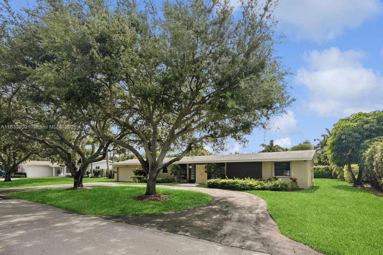 Fabulous location just steps from Coral Reef Park and school on a quiet, family-friendly street. This well-maintained 3-bedroom split plan offers a private primary suite on one side and two spacious bedrooms on the other. The updated kitchen features warm wood cabinetry, Corian countertops, and white appliances. The remodeled primary bath is designed for handicap access. Light tile and carpet flooring throughout. Enjoy year-round entertaining in the large screened-in pool and patio area. 2 car garage along with circular driveway for easy parking. Laundry area and ample yard space complete this inviting home.