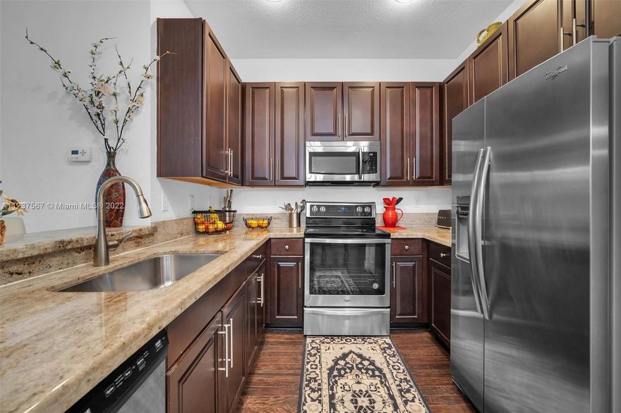 Extremely clean and luxurious Mediterranean tri-level townhouse with a full 3 beds / 3.5 baths / 2-car garage. Upgraded kitchen with granite counter tops, dark wood cabinets + stainless steel appliances. Spacious primary suite on 3rd floor has dual closets and a primary bath with dual sinks, along with a separate tub and shower. Gorgeous white plantation shutters + REAL wood floors throughout the home. HURRICANE IMPACT WINDOWS with FULL SIZE WASHER AND DRYER. Playground in courtyard steps away- visible from multiple windows and patio. Community boasts a gated entrance, clubhouse with full kitchen, pool, gym, and over 1 mile of scenic paths that wraps around the lake. Montclair is conveniently located near Turnpike, I-75, restaurants and shopping.