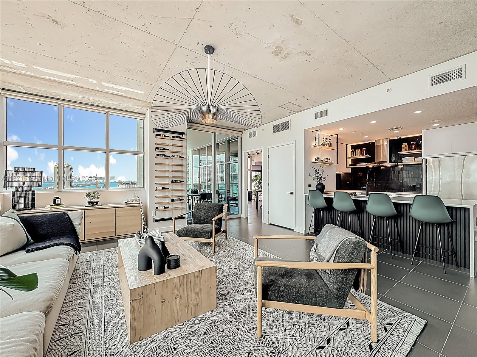 Fully designer-renovated corner residence in the rarely available 15 line at 4 Midtown. Bright and airy with abundant natural light and panoramic views of Biscayne Bay and the ocean. Spacious L-shape balcony is perfect for dining and entertaining. Custom kitchen features Bianca Calore polished quartz countertops, marble backsplash, 32-bottle Vinotemp wine fridge, induction cooktop, vent hood, and new appliances. Both bathrooms fully upgraded with premium finishes, rain shower, bench and bathtub. Motorized blackouts in bedroom, manual shades in living room. New AC, water heater, and washer/dryer. Full-service building with infinity pool, fitness center, spa, sauna, jacuzzi, 24/7 concierge & security. Pet-friendly. Steps to Design District, Wynwood, Trader Joe’s, Whole Foods, parks & more.