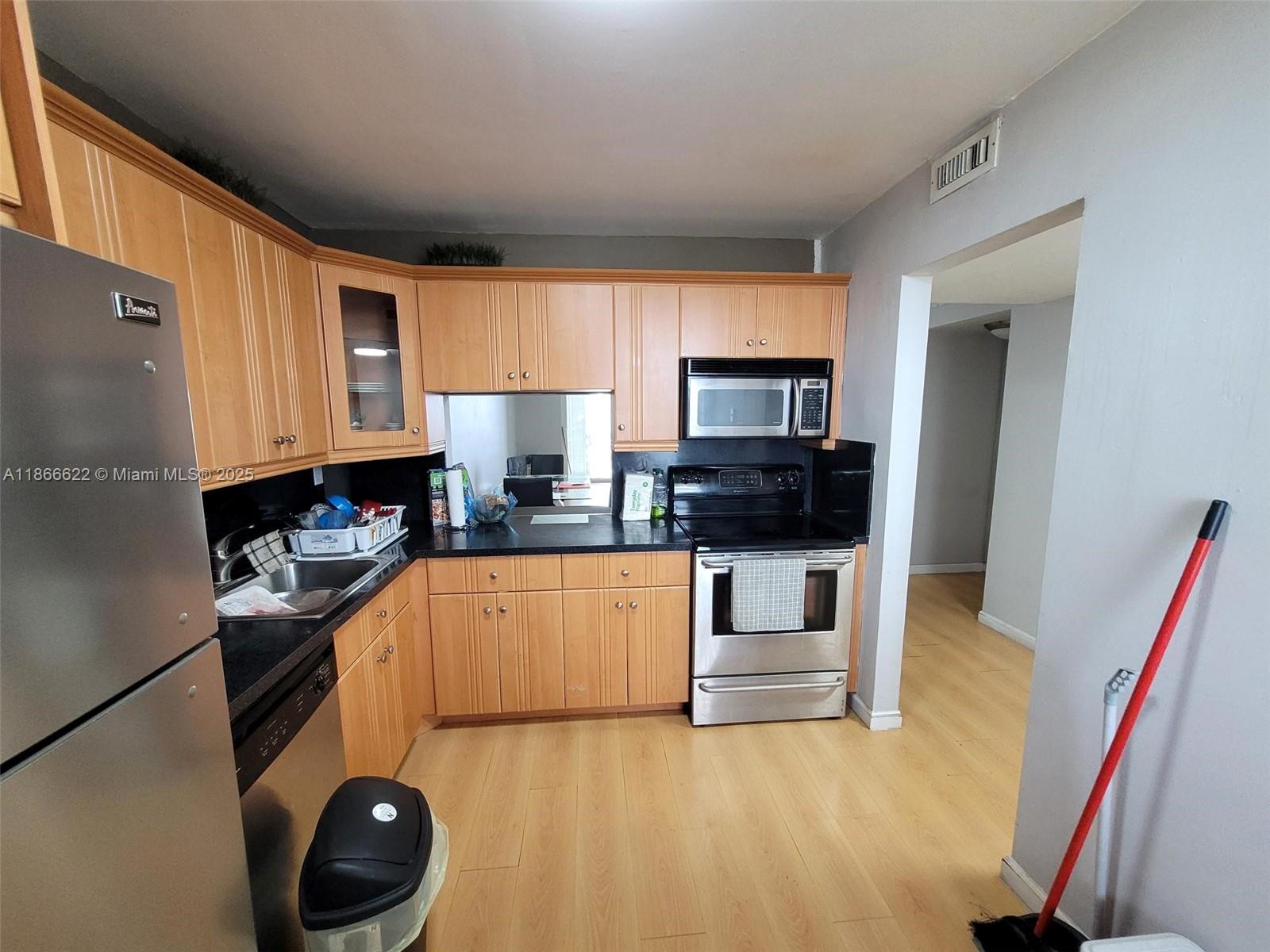 Spacious 921 SQ FT, 1 bedroom/1.5 bathroom condo is situated on the 9th floor in a peaceful and sought-after 55+ community just west of Aventura. Features: impact windows, stainless steel kitchen appliances, ample closet space, and a large balcony with tranquil lake views, complete with shutters for weather protection, redone half bathroom, and laminate floors throughout. The community offers 2 heated pools, a fitness center, sauna, and a clubhouse. Conveniently located near houses of worship, Publix, shopping, dining, hospitals, and major highways. Includes 1 assigned parking spot and plenty of guest parking. Maintenance covers water, basic cable, trash, & laundry room on every floor. The building is well-maintained with low HOA fees.