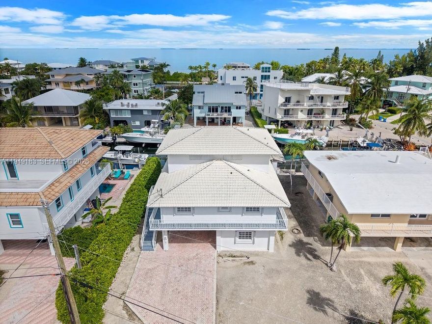 Welcome to 106 Lisbon Court, an exceptional opportunity in the prestigious Port Antigua community of Islamorada. Perfectly situated in one of the Keys' most sought-after neighborhoods, this three-level residence combines an enviable coastal lifestyle with rare amenities, including 60 feet of dockage for your boat and direct access to world-class fishing and turquoise waters. The home's thoughtful design features an updated kitchen, inviting living areas for entertaining, and a private third-level primary suite that serves as your personal retreat with serene views. Outdoor spaces provide the ideal setting for gatherings or quiet evenings under the island breeze. Beyond the property itself, Port Antigua offers unmatched lifestyle benefits with a private white-sand beach, community boat ramp
