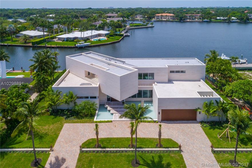 Groundbreaking entrance of modern architecture into Coral Gables! Iconic estate w/171 Sq Ft of waterfrontage with direct ocean access is uniquely positioned to allow for wide open water views. Exterior walls covered with natural stone from Spain & custom doors handmade from Ecuadorian solid wood contribute to the luxurious allure. Floating Master Suite & second-floor rooftop terrace provide stunning views. Home boasts an open layout, elevator, gourmet kitchen w/Italian Calacatta marble & Miele appliances, infinity pool & spa & new sea wall. The property also comes equipped with a low voltage wiring system to allow for full smart home technology. Additional features include, 3 car garage & opportunity to build a large dock, offering direct access to the Atlantic Ocean for your luxury vessel