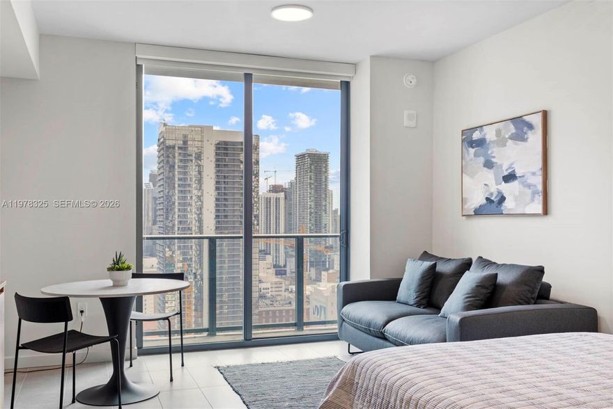 Stunning fully furnished studio featuring breathtaking views of the Miami skyline. This modern residence is move-in ready—just bring your personal belongings. Located in a newer building in the heart of Downtown Miami, the apartment offers a comfortable and stylish living space with contemporary finishes.
Enjoy unbeatable convenience with the Metromover station located directly across the street and walking distance to Miami Worldcenter, one of Miami’s most exciting destinations for shopping, dining, and entertainment.
The building offers world-class amenities including a fully equipped fitness center, pool, lounge areas, and a co-working space ideal for remote work or study. Internet and cable are included in the rent, providing added value and convenience.
Perfect for those seeking an urban lifestyle with easy access to transportation, entertainment, and everything Downtown Miami has to offer.