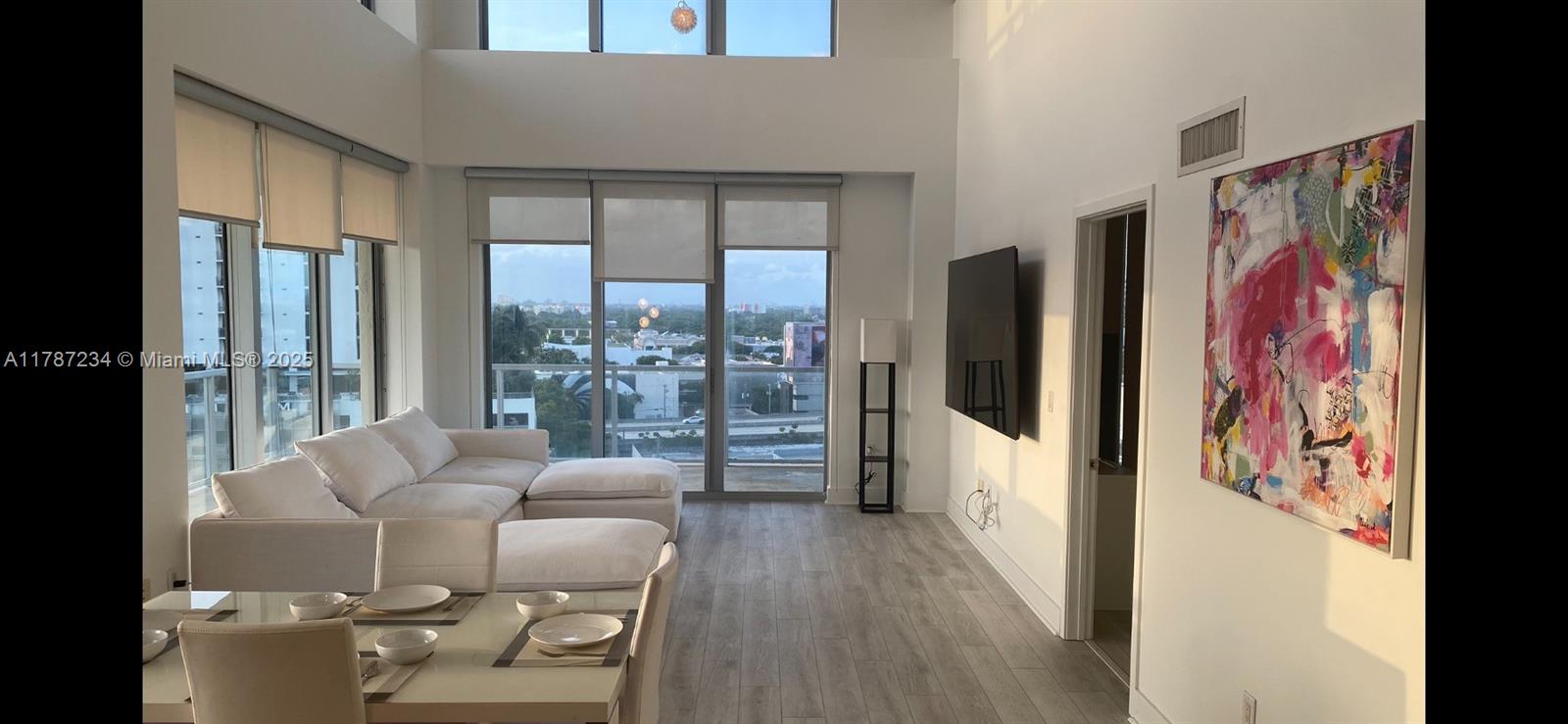 Modern apartment in Midtown Miami with 2 bedrooms and 2.1 bathrooms. New floors. This PH apartment offers an open floor plan with Double-Height ceilings, floor-to-ceiling windows, lots of natural light, master bedroom located in the 2nd level with open rain shower, walk-in closets, double wrap-around balconies with stunning city views including the modern Miami Design District architecture. Indulge in resort-style amenities including a pool with cabanas, fitness center, jacuzzi, sauna, outdoor lounge area and a 24-hour front.