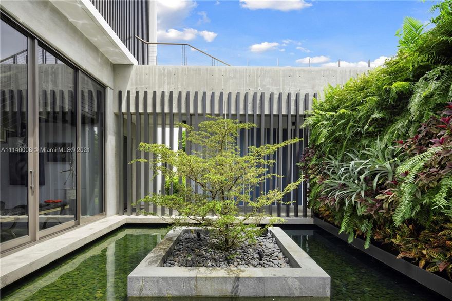 A true masterpiece in the heart of Ponce-Davis, one of Miami's most coveted neighborhoods. Artfully designed by famed architect Ralph Portuondo, the stunning residence features 8 ensuite bedrooms + 2 half baths, home office, multiple family rooms + impressive entry/living area w/25-foot ceilings + gym w/full bath. Marble floors throughout w/no detail spared. This home is an entertainer's dream w/2 kitchens, including fully-equipped chef's kitchen, ample indoor/outdoor dining spaces, a Baccarat room + full wine room. There are 2 1-bedroom ensuite guest suites above air-conditioned 4-car garage + 2 detached 1-bedroom ensuite guest suites. The 56,628 SF, gated grounds w/lush, custom landscaping feature a sunken garden, outdoor pool, koi, lily ponds + multiple fountains. A true masterpiece!