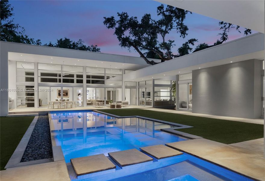 Price now reduced for a tropical paradise located in a gated enclave in the heart of Coconut Grove. This masterpiece of modern Miami luxury, designed by Roney Mateu, is an award-winning 5,825 adj. sf one-story home built in 2012 and situated masterfully on a 16,575 sf lot. The home features 4 bds, 4.5 ba, European kitchen, baths & closet systems, dual walk-in closets in primary suite, ensuite bedrooms & detached 1bed/1ba + office guesthouse. Indulge in ultimate outdoor living with deep covered patios with summer kitchen, lap pool with sun ledge & spa. Featuring 17 foot ceilings in main living areas, impact glass, 2-car garage & min to the Village center. The adjacent vacant lot is a companion listing (MLS: A11601146) with an additional 15,941 sf and can be sold together or separately.