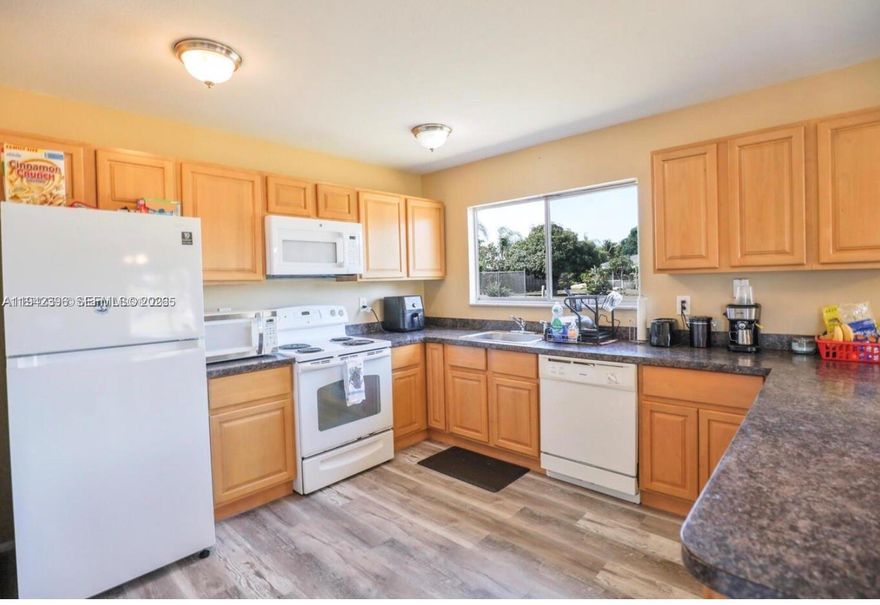 MOTIVATED SELLER & OPEN TO CONCESSIONS THIS 3-bedroom, 2-bath single-family home situated on an oversized 0.3-acre lot in the desirable Whispering Pines area of Port St. Lucie. Offering 1,176 sq. ft. of comfortable living space, this residence features a spacious split floor plan, a bright kitchen with essential appliances, and a cozy living area perfect for gatherings. The exterior boasts a covered patio and plenty of room to add a pool or create your dream backyard oasis. Conveniently located near shopping, dining, schools, and with easy access to I-95 and the Turnpike, this property combines value, location, and lifestyle