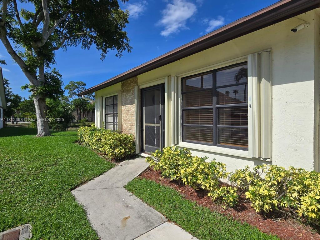 Photo of 1120 Parkside Green Dr #A, Green Acres, FL 33415 (MLS # A11812398)