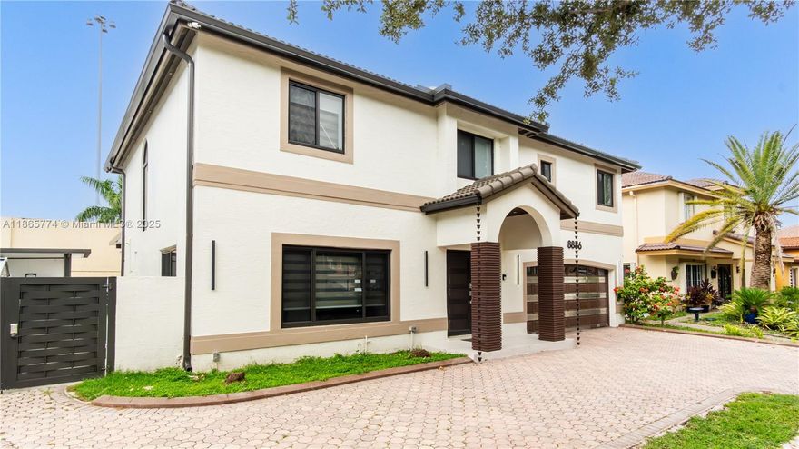 Located in a prestigious gated community on the Miami-Dade/Broward line, this residence offers a modern open-concept layout with sleek tile flooring, high ceilings, and impact windows. The gourmet kitchen includes top-of-the-line appliances, elegant cabinetry, and contemporary finishes. The bathroom has been remodeled with premium materials for a refined touch. Outdoor features include a spacious patio and a private pool, ideal for entertaining or relaxing. Combining security, functionality, and style, this property delivers the perfect South Florida living experience.