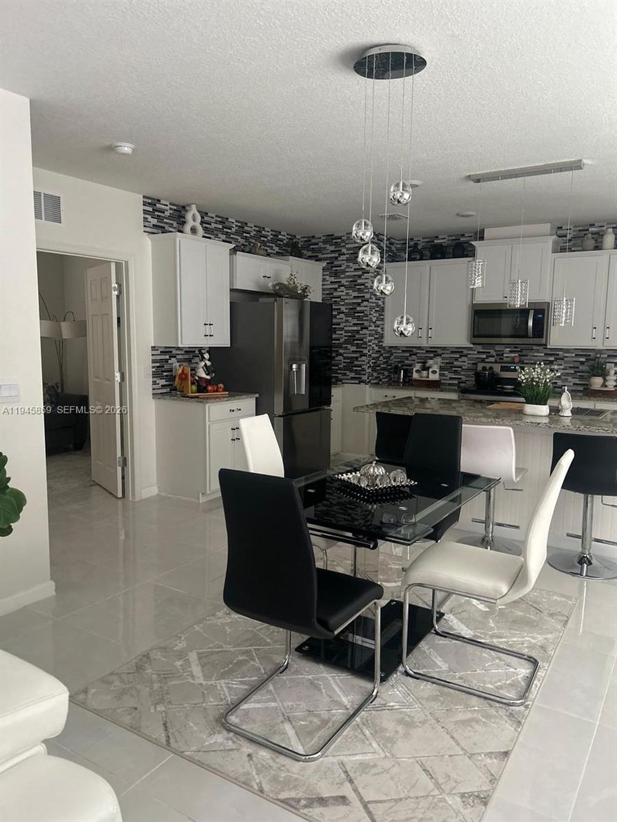 Beautifully upgraded waterfront home featuring porcelain tile flooring throughout and a bright, open-concept layout designed for comfortable living and entertaining. The modern kitchen showcases white cabinetry, granite countertops, stainless steel appliances, a spacious center island, and ample storage. The  light fixtures add a contemporary touch and enhance the home’s natural light.
The home is equipped with a smart house system that allows convenient control of lighting, climate, and security.

The primary suite offers a peaceful retreat with generous closet space and a well-appointed bathroom. Additional bedrooms provide flexibility for guests, a home office, or hobby space.

Step outside to a covered patio with a newly added gazebo, ideal for outdoor dining, relaxing, or enjoying serene water views and Florida sunsets.

Located in a sought-after, amenity-rich community featuring a resort-style clubhouse, elegant gathering spaces, game and entertainment rooms, tennis, pickleball, Basketball, catering kitchen, playground, and a large resort-style swimming pool with sundeck and lounge areas. Conveniently close to shopping, dining, golf, and major highways. Move-in ready and perfectly suited for the Florida lifestyle.