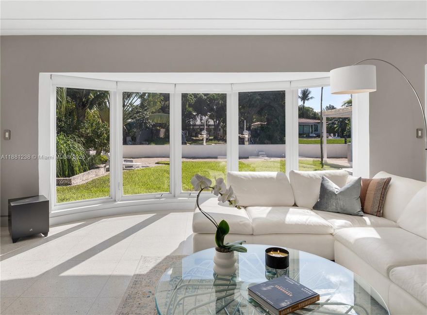 Step into this bright, updated Miami Beach home on guard-gated Biscayne Point. Lush landscaping welcomes you to a light-filled residence designed for indoor-outdoor living. An open floor plan enhances the home's flow yet preserves pockets of privacy and comfort. Enjoy an expansive waterfront setting with a boat lift and no fixed bridges to the ocean. A brand new spacious covered outdoor entertaining area, featuring a concrete L-shaped bar, is perfect for hosting gatherings. Modern upgrades and open interiors make this a serene retreat just minutes from beaches, dining, and shopping.
