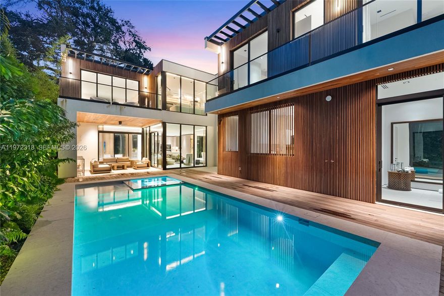 Introducing CASA GRANDE, a striking architectural statement set on a premier corner lot in the heart of Coconut Grove. Designed by Bernardo Paredes and developed by The Modd Group, this 7-bedroom, 7-bathroom modern estate seamlessly blends bold design with refined comfort and functionality.
A dramatic double-height foyer and sculptural floating staircase set the tone for sophisticated interiors. Expansive living and dining areas flow into a state-of-the-art chef’s kitchen with premium appliances and an oversized walk-in pantry. The main level also features a custom family room, private office, full laundry room, two-car garage, and a versatile yoga suite/cabana with full bath.
Upstairs offers five spacious ensuite bedrooms, including a luxurious primary suite, plus a second-floor lounge ideal for relaxing or movie nights.
Designed for effortless indoor-outdoor living, the home opens to a covered terrace with summer kitchen, resort-style pool and spa, and lush tropical landscaping for ultimate privacy.
Available turnkey furnished and move-in ready.