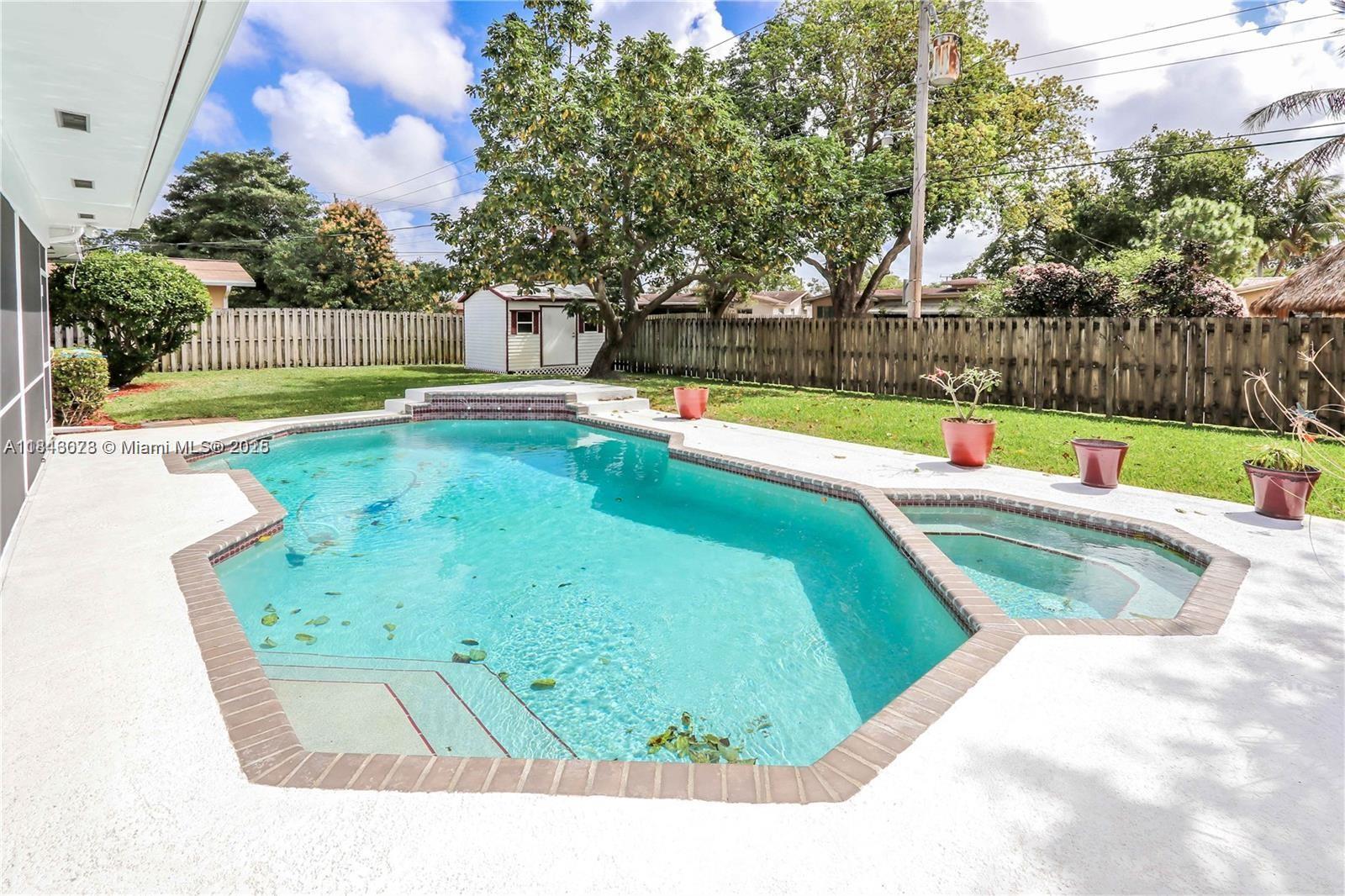Step into this beautifully updated 4-bedroom, 2-bath pool home with 2 car garage, that blends comfort and style in every corner. Inside, you’ll find a bright, open layout with brand new vinyl plank flooring and impact windows and doors for peace of mind. The heart of the home, the kitchen, features elegant 42-inch cabinets, a double oven, and modern finishes perfect for gatherings. Both the A/C unit and ductwork are brand new, along with fresh blown-in attic insulation. Cozy up by the electric fireplaces in the living room and primary suite, and enjoy easy mornings with refreshed bathrooms. The flat roof in the back was replaced just last year, offering added value and durability. This home is move-in ready and perfect for relaxing poolside or entertaining in comfort.