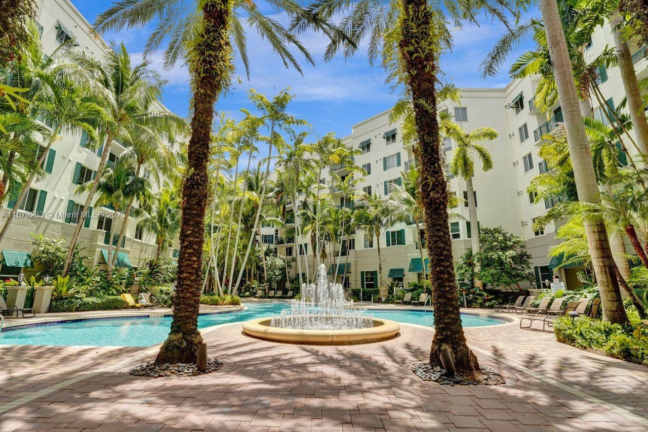 ELEGANT 2/2 Corner condo with elegantly appointed lobby, "NEW LAMINATE FLOORS THROUGHOUT". **Resort-style tropical pool, and Jacuzzi, 24-Hour manned security at front desk, high-tech security system, state-of-the-art fitness center, dry sauna, club room, four floors of assigned secure and covered parking Unit Features: Large CORNER Balcony, granite counter top in kitchen, stainless steel kitchen appliances, European cabinetry, marble shower and soaking bathtub in the bathroom, smart key fob entry into building washer and dryer in unit.