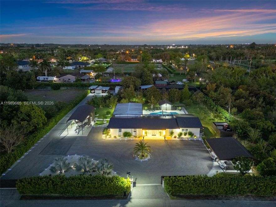 Beautiful Redland estate located in the highly sought-after Bonanza Estates, fully remodeled with no expense spared and designed for both luxury living and long-term value. This exceptional home features a brand-new 2026 metal roof, completely updated electrical and plumbing systems, a full-house Generac generator, and a brand-new Aqua Water Tech filtration system for enhanced water quality and peace of mind. A grand double electric gate welcomes you to a stunning circular driveway with ample parking and a detached four-car carport, creating an impressive arrival experience. Inside, enjoy elegant ceramic tile flooring throughout, a gorgeous gourmet kitchen with high-end finishes, and a thoughtfully designed split-bedroom layout offering maximum privacy, highlighted by a spacious primary suite. Step outside to your private resort-style oasis featuring a heated saltwater pool, perfect for entertaining and family gatherings, along with a full cabana bath for added convenience. The outdoor experience continues with a beautifully designed gazebo featuring a complete outdoor kitchen and a dedicated TV lounge area, ideal for hosting and unforgettable gatherings. The expansive grounds include over 100 mature fruit trees—mamey, mango, guava, avocado, and more offering both a serene lifestyle and the potential for additional yearly income. A rare opportunity to own a truly turnkey estate in the heart of the Redlands.