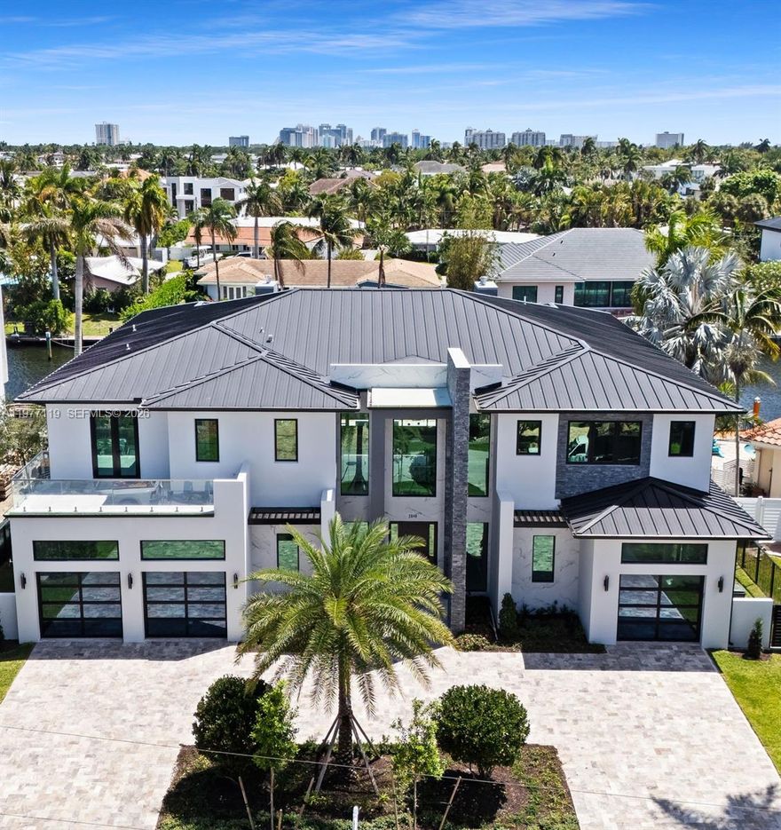 Unparalleled luxury in the prestigious heart of Coral Ridge. This brand-new construction single-family home sets a new standard in bespoke living. From the moment you enter, you'll be captivated by the exclusive design, boasting high-end finishes and imported tiles throughout.

This residence offers an impressive climate-controlled  four-car garage, ensuring ample space for your luxury vehicles. The layout includes 5 spacious bedrooms, 5 bathrooms including steam shower and sauna in primary bedroom, 2 power rooms, and dual laundry rooms .

Enjoy resort-style amenities with a heated pool and spa, complete with an outdoor fireplace and fully equipped commercial grade outdoor kitchen, perfect for entertaining. 

Boasting 95 feet on the water with no fixed bridges, this property is a boater's dream. Built on a foundation designed for a skyscraper, this home promises unmatched stability and security. The chef's kitchen is a culinary haven, equipped with top-of-the-line Dacor appliances and complemented by a butler's pantry for additional storage and preparation space. 

This home is not just a residence; it's a lifestyle. Experience the epitome of luxury living in Coral Ridge with this unparalleled, customized property unlike anything else on the market. Don’t miss your chance to own this architectural gem. Schedule your private tour today and step into a world of sophistication and grandeur.